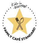 A yellow star with an illustration of a knife and fork crossed over it and the words Kids in Museums Family Café Standard